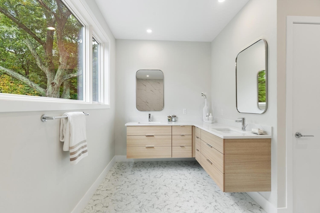 6 Linc Cole Lane Lexington, MA 02421 - Photo 21 of 30 a bathroom with a double vanity sink a mirror and a bathtub