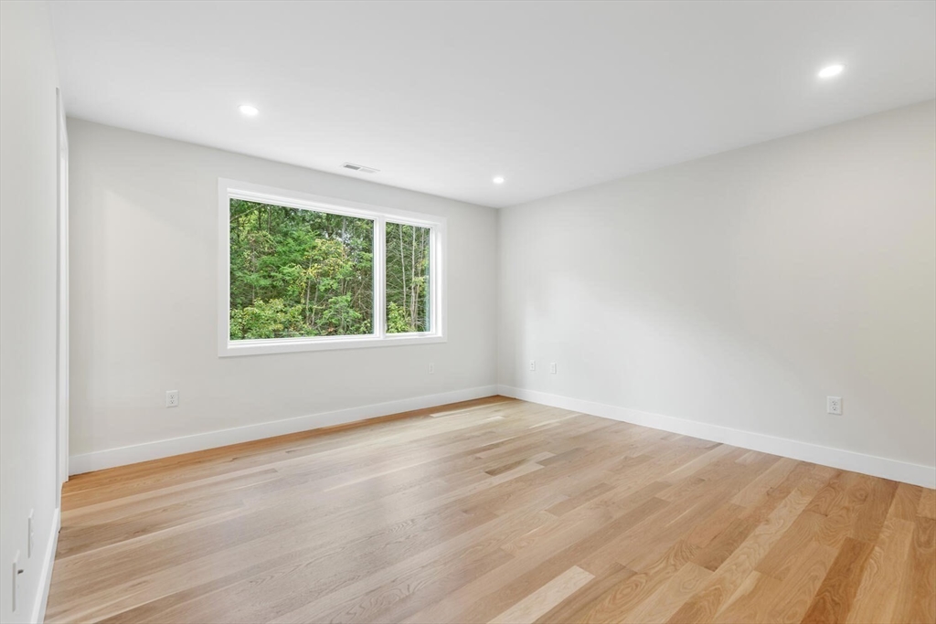 6 Linc Cole Lane Lexington, MA 02421 - Photo 22 of 30 an empty room with wooden floor and windows