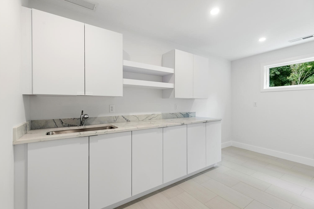 6 Linc Cole Lane Lexington, MA 02421 - Photo 23 of 30 a room with a sink cabinets and a window
