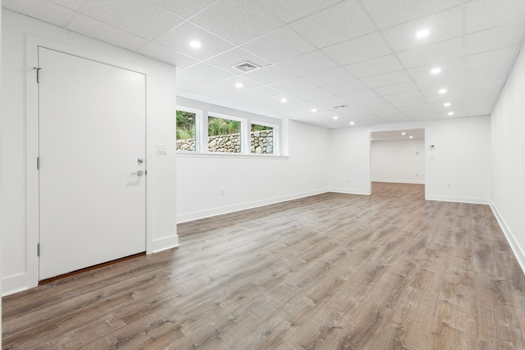 6 Linc Cole Lane Lexington, MA 02421 - Photo 25 of 30 an empty room with wooden floor and windows