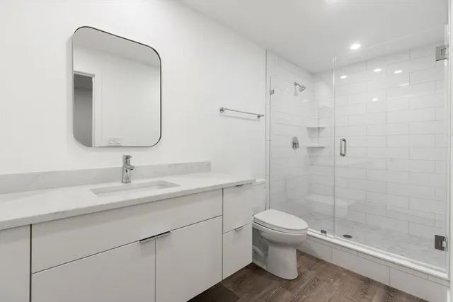 a bathroom with a toilet a sink and shower