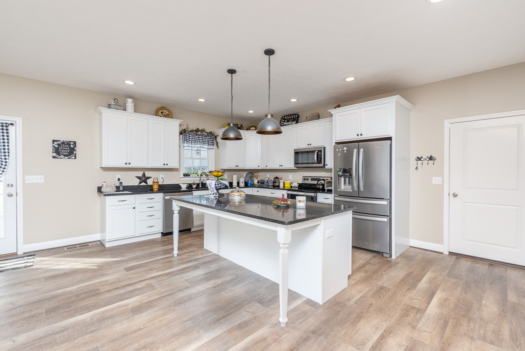 115 Ridgemore Drive Raphine, VA 24472 - Photo 11 of 42 a kitchen with white cabinets and stainless steel appliances