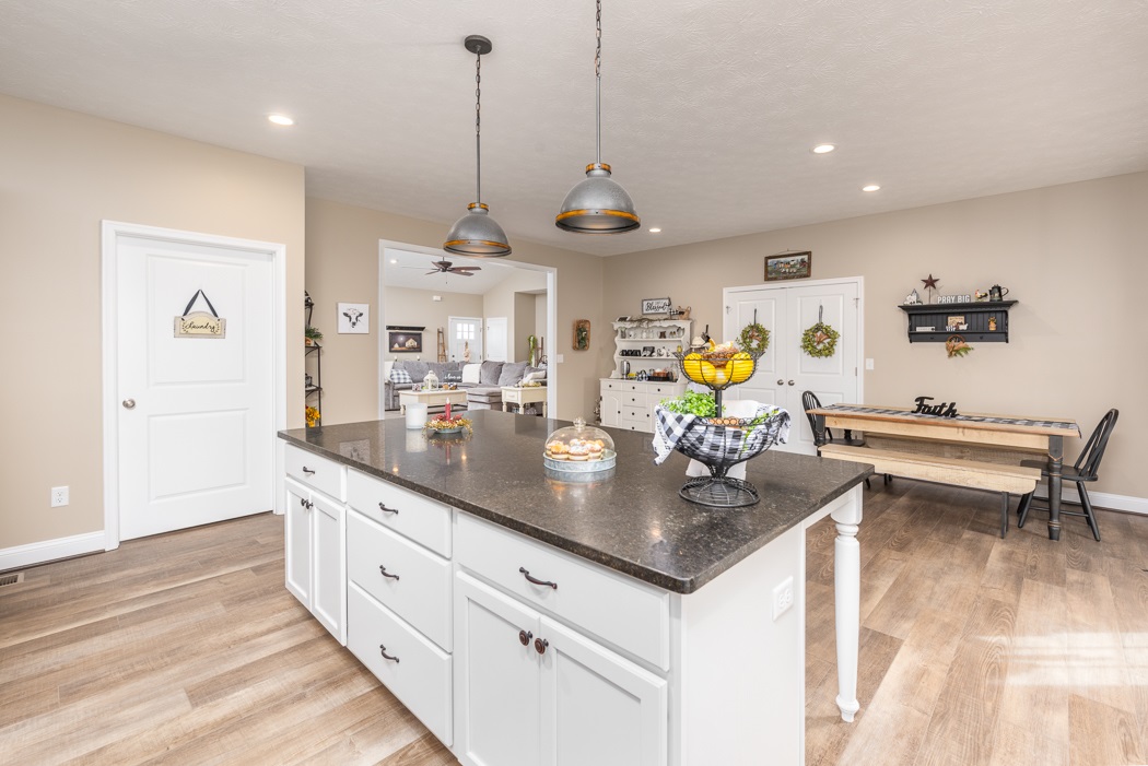 115 Ridgemore Drive Raphine, VA 24472 - Photo 13 of 42 a room with stainless steel appliances kitchen island granite countertop a table chairs in it and wooden floors