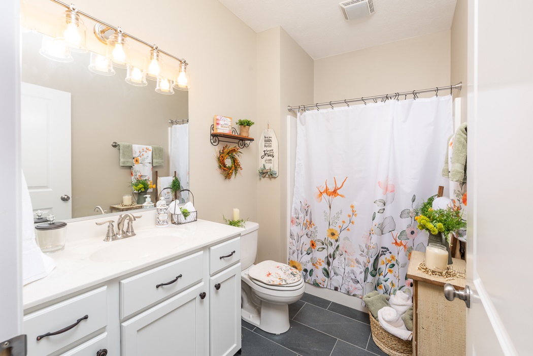 115 Ridgemore Drive Raphine, VA 24472 - Photo 31 of 42 a bathroom with a granite countertop sink a toilet and a mirror