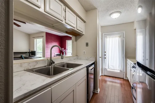 a kitchen with stainless steel appliances granite countertop a sink stove and cabinets