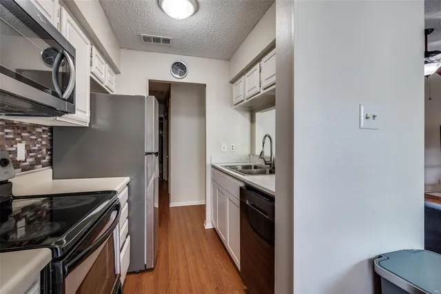 a kitchen with stainless steel appliances granite countertop a stove and a refrigerator