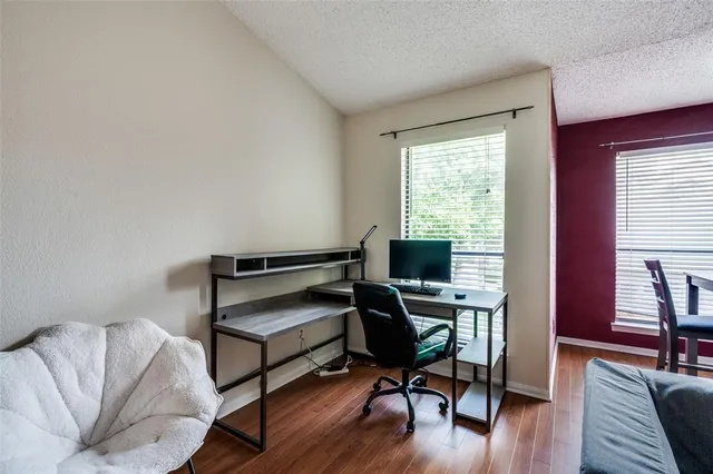 a view of a workspace with furniture and a window