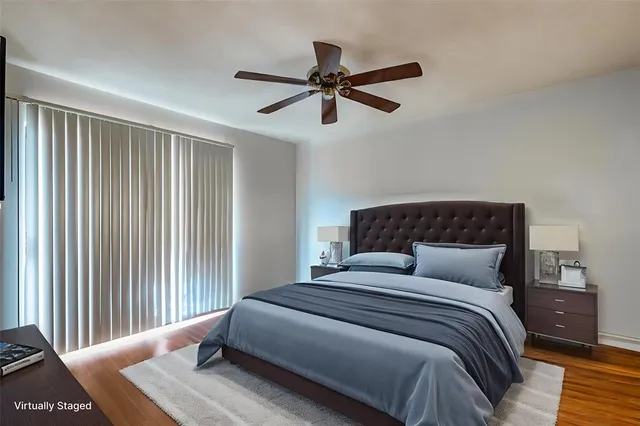 a bedroom with a large bed and a chandelier