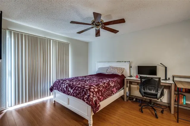 a bedroom with a bed a desk and chair