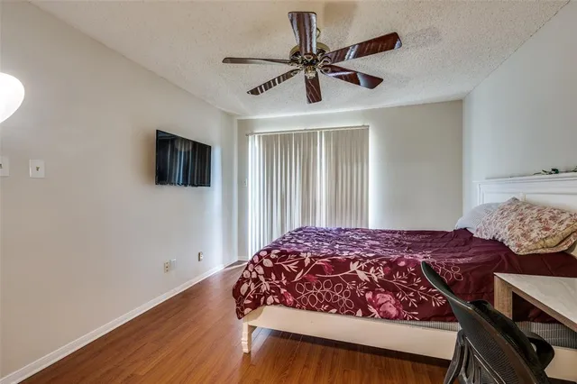 a bedroom with a bed and a tv