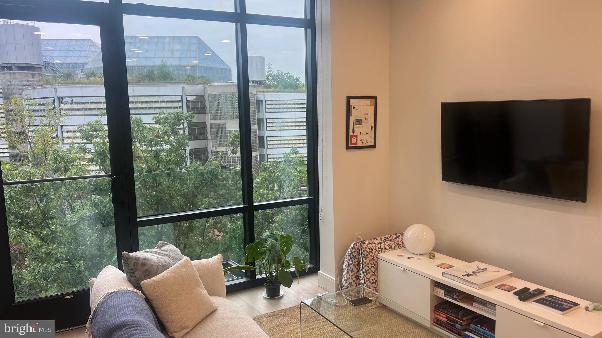 4111 Connecticut Avenue Northwest, Unit 502 Washington, DC 20008 - Photo 2 of 7 a living room with furniture and a flat screen tv