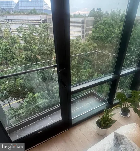 a view of a floor to ceiling window and a wooden floor