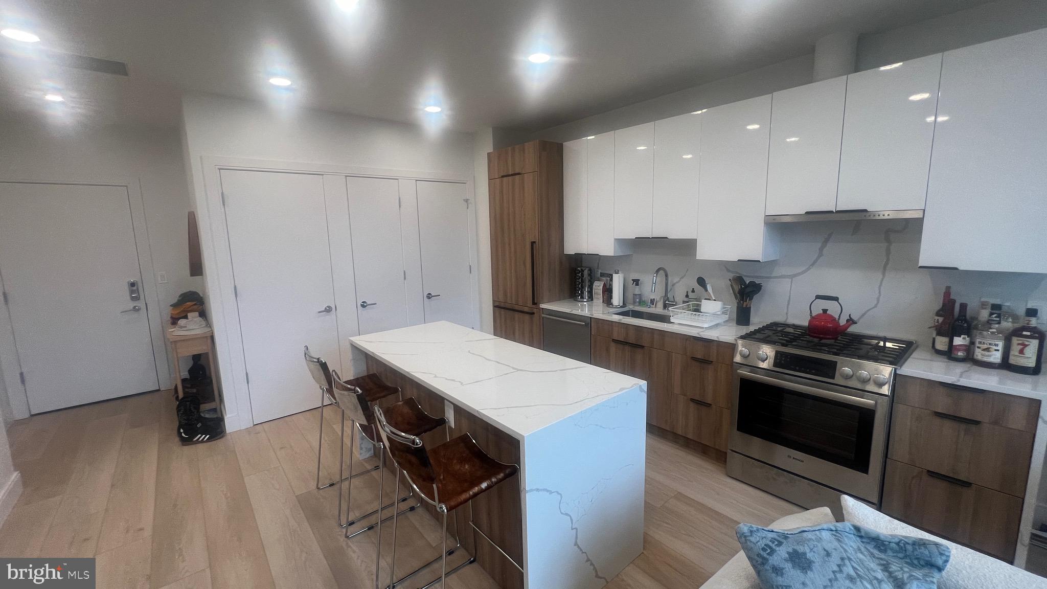 4111 Connecticut Avenue Northwest, Unit 502 Washington, DC 20008 - Photo 5 of 7 a kitchen with a sink a stove a refrigerator and cabinets