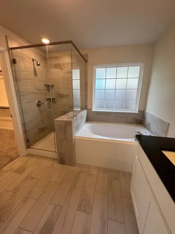 a kitchen with granite countertop a sink and white cabinets