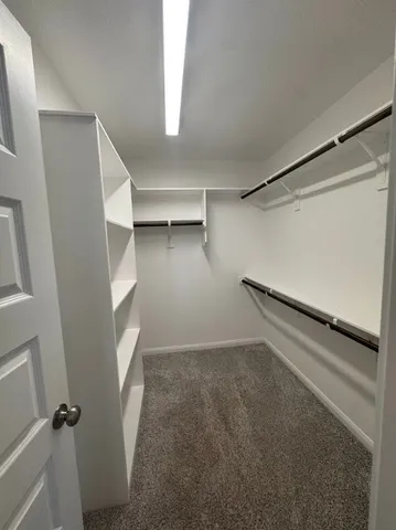 a spacious bathroom with a tub a sink and a shower