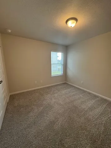 a view of a hallway with wooden floor and closet