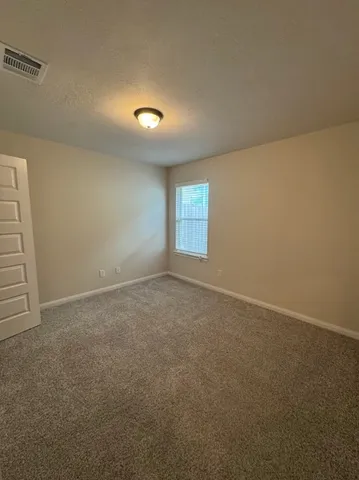 en empty room with windows and yard