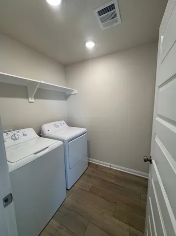 a view of storage and utility room with washer and dryer