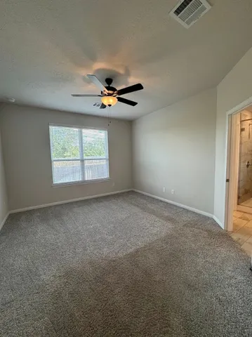a view of empty room with wooden floor and a ceiling fan
