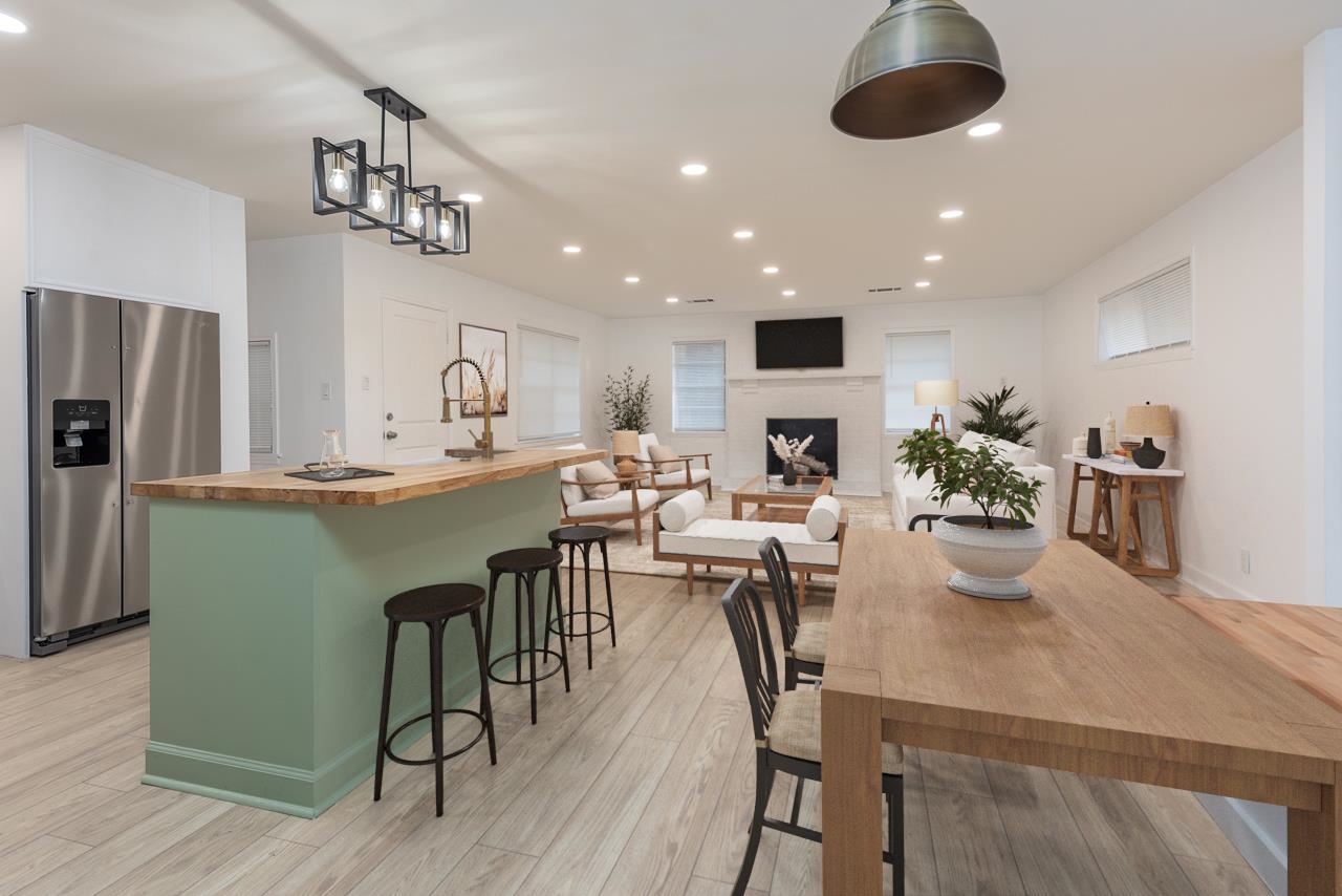 4771 Sea Isle Road Memphis, TN 38117 - Photo 1 of 12 a kitchen with stainless steel appliances kitchen island granite countertop a table chairs and a refrigerator