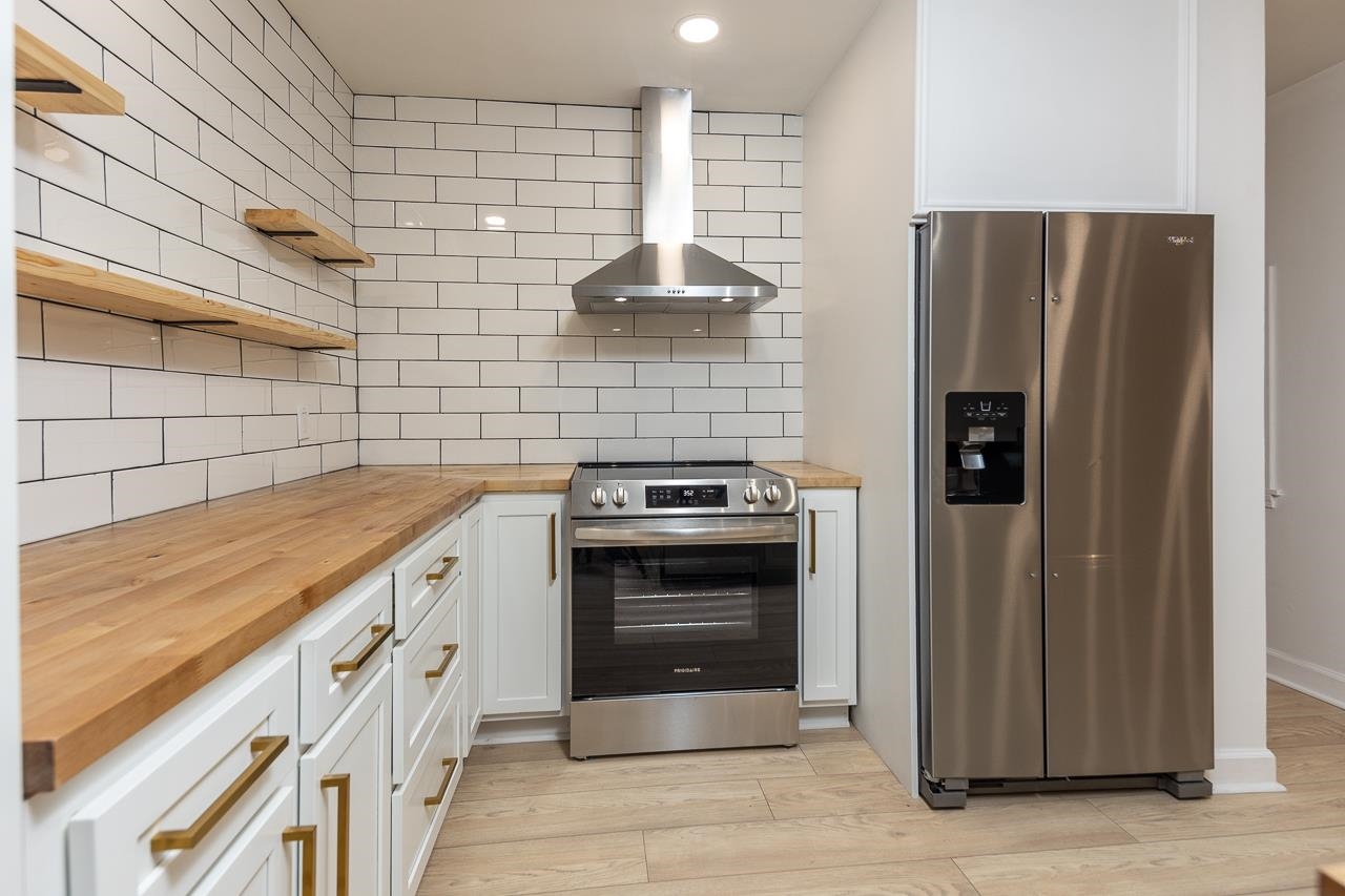 4771 Sea Isle Road Memphis, TN 38117 - Photo 2 of 12 a kitchen with stainless steel appliances granite countertop a refrigerator and a stove