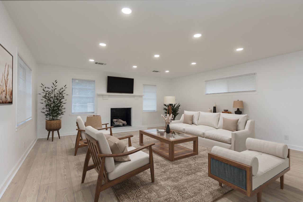 4771 Sea Isle Road Memphis, TN 38117 - Photo 4 of 12 a living room with furniture a fireplace and a flat screen tv