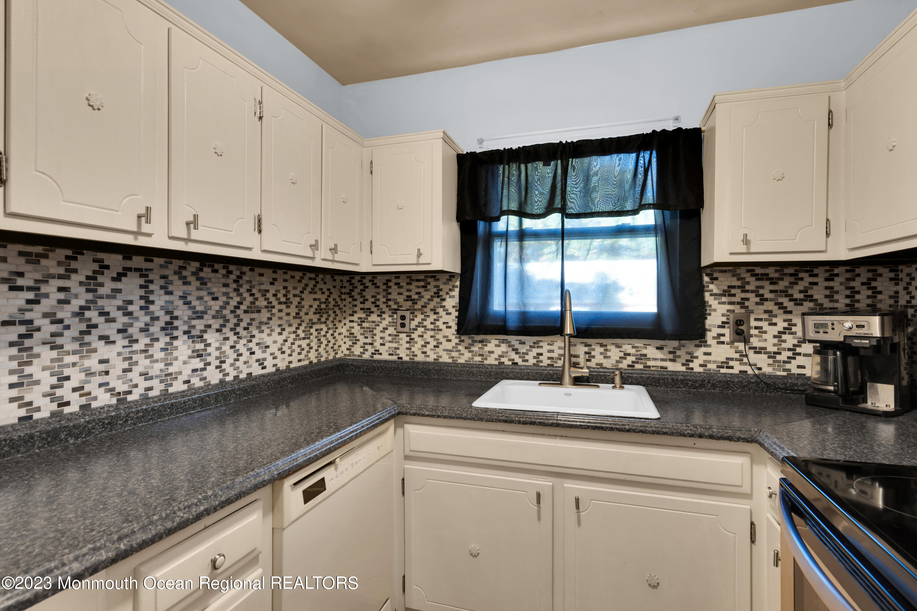 142 Azalea Drive, Unit B Whiting, NJ 08759 - Photo 14 of 27 a kitchen with a sink and cabinets