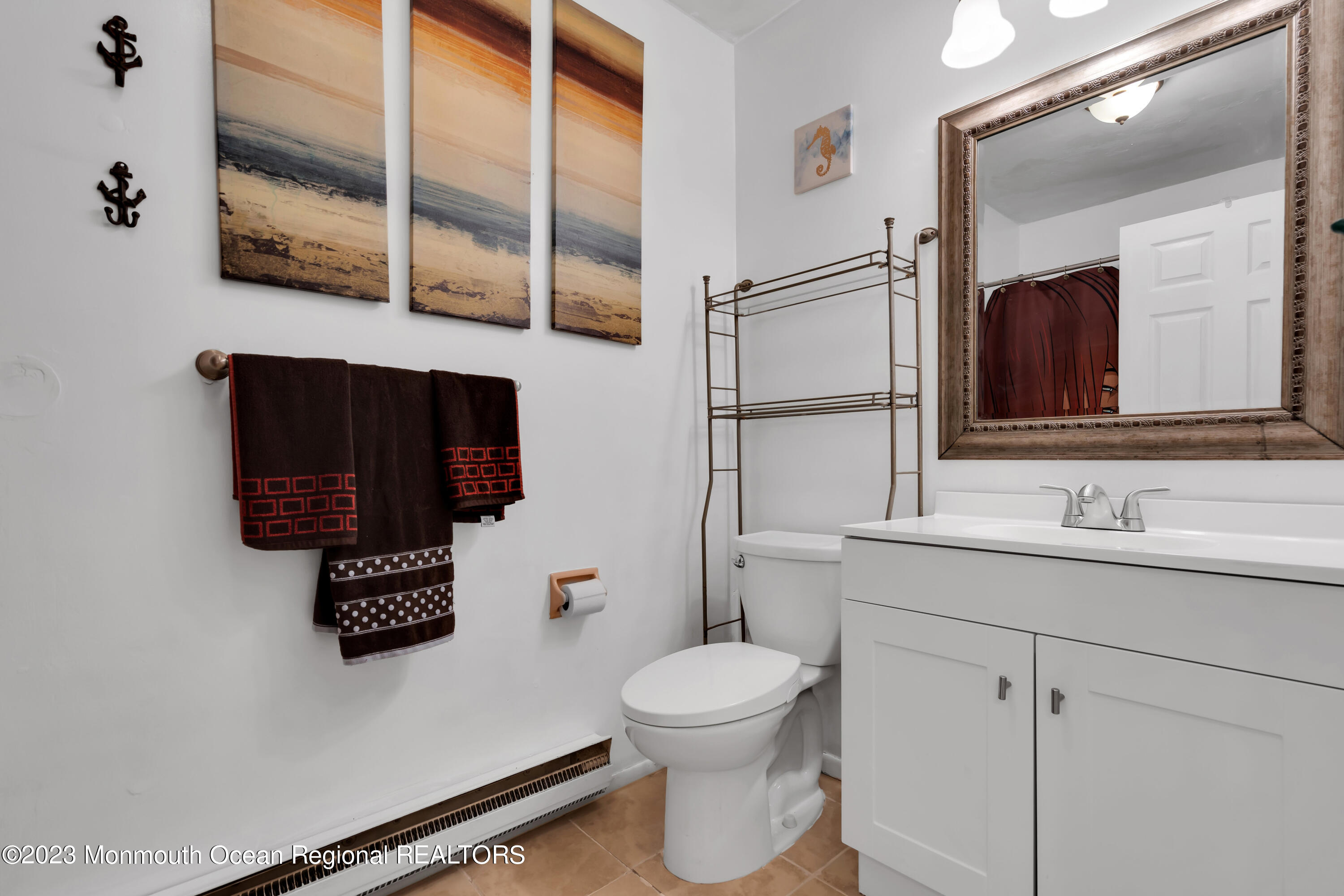 142 Azalea Drive, Unit B Whiting, NJ 08759 - Photo 19 of 27 a bathroom with a toilet sink a mirror and shower