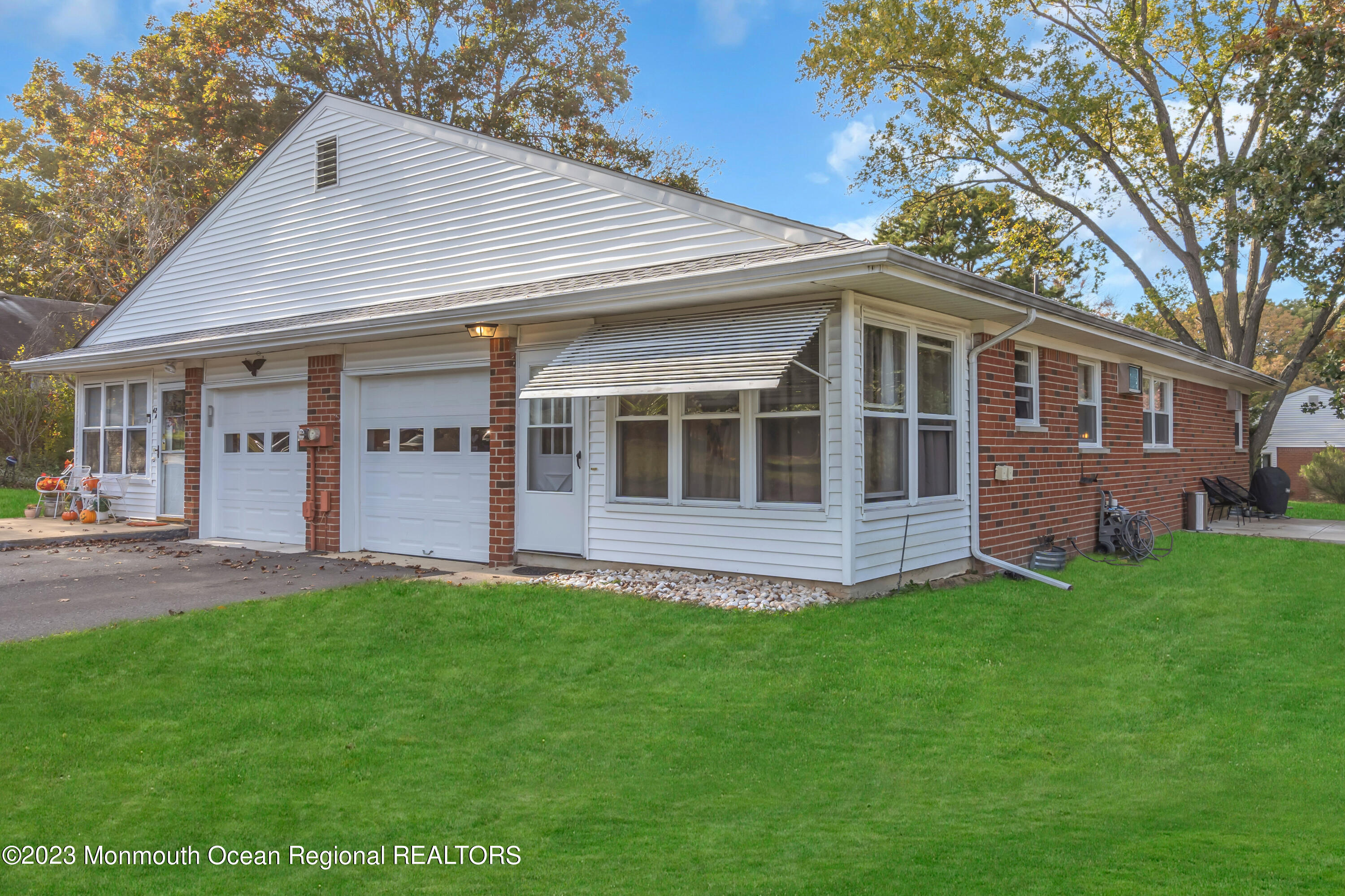 142 Azalea Drive, Unit B Whiting, NJ 08759 - Photo 2 of 27 a view of a house with a yard and sitting area