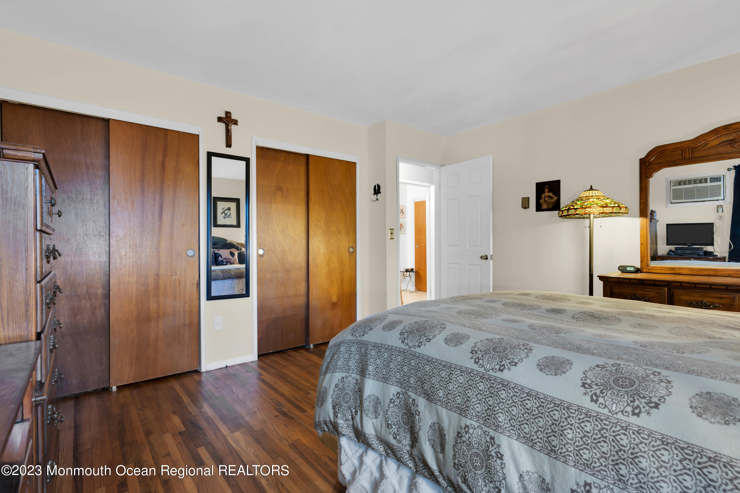 142 Azalea Drive, Unit B Whiting, NJ 08759 - Photo 23 of 27 a bedroom with a bed and a flat screen tv