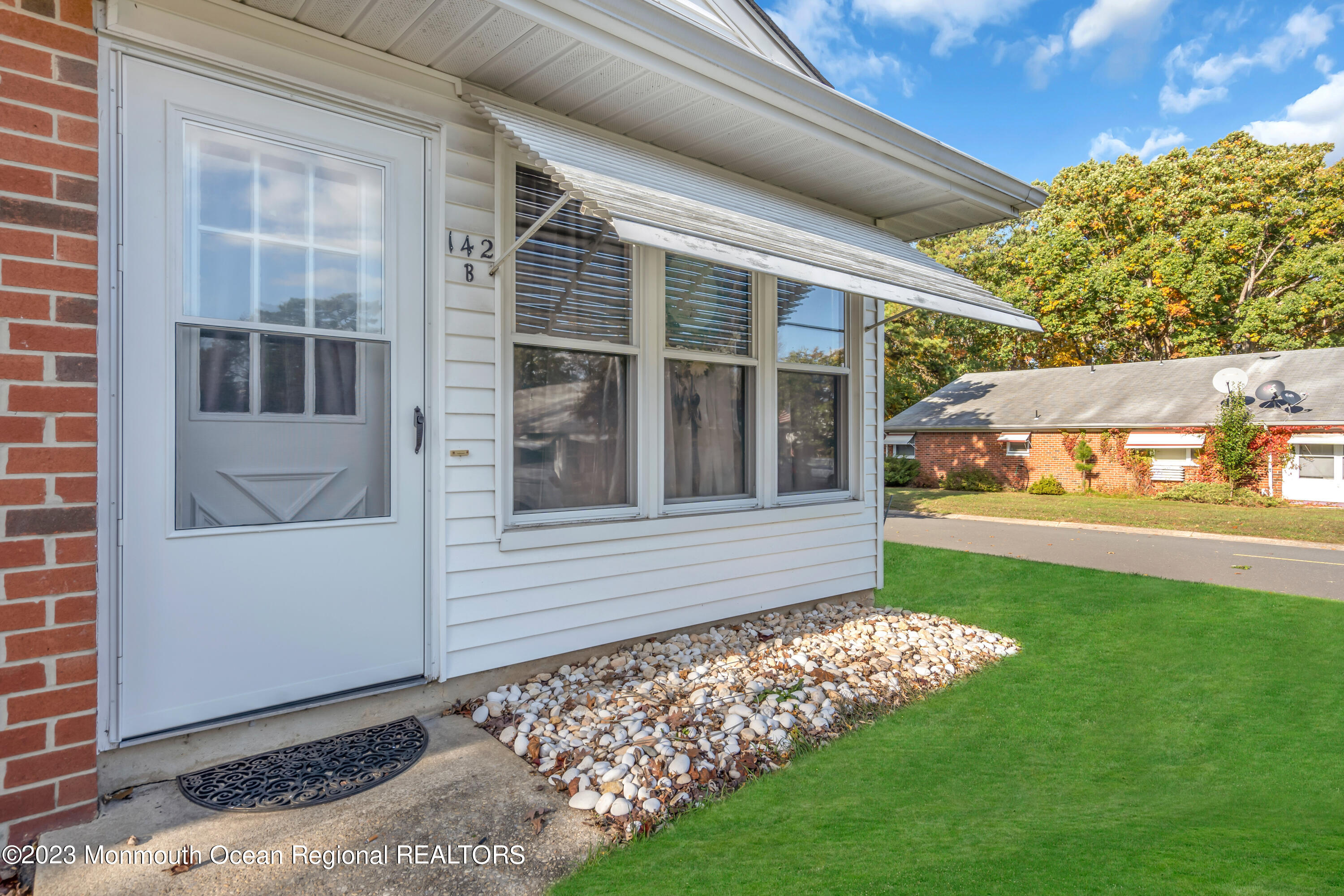 142 Azalea Drive, Unit B Whiting, NJ 08759 - Photo 5 of 27 a view of a house with a yard