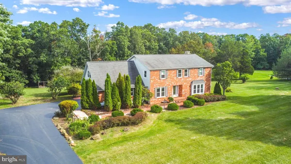 an aerial view of a house with a yard