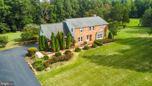 a view of a big yard with a house in the background