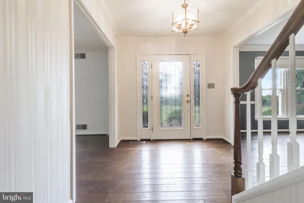 a view of empty room with wooden floor and windows