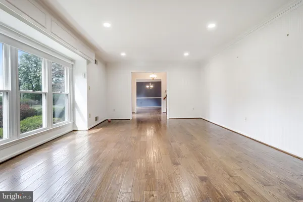 a view of a room with wooden floor and cabinet