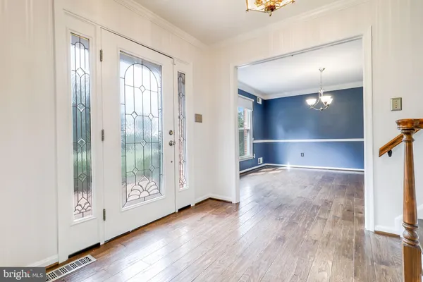 a utility room with wooden floor washer and dryer