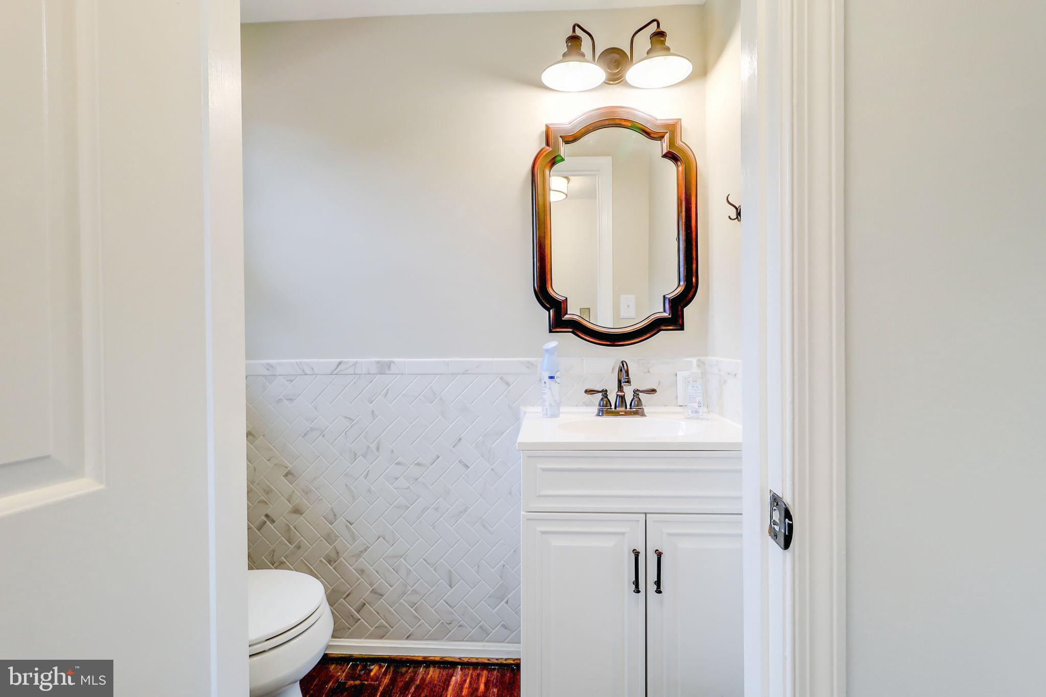21960 Oatlands Road Aldie, VA 20105 - Photo 44 of 79 a bathroom with a sink a toilet and a mirror