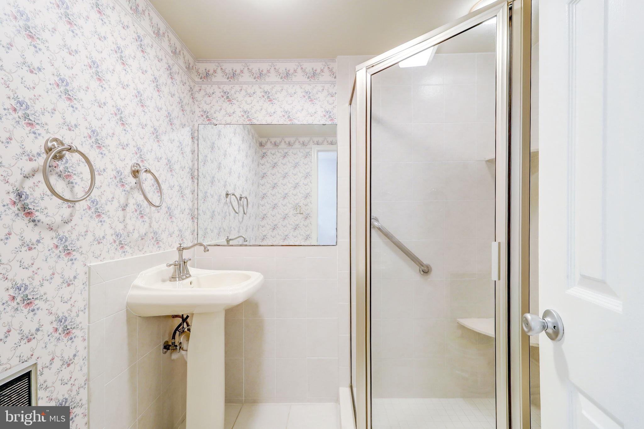 21960 Oatlands Road Aldie, VA 20105 - Photo 49 of 79 a bathroom with a sink mirror and shower