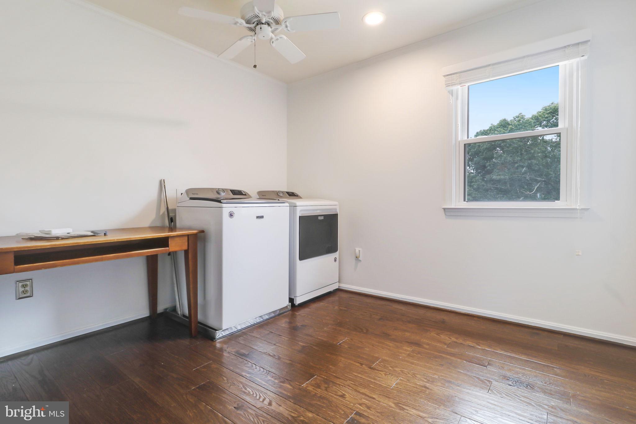21960 Oatlands Road Aldie, VA 20105 - Photo 59 of 79 an empty room with wooden floor cabinet and a ceiling fan