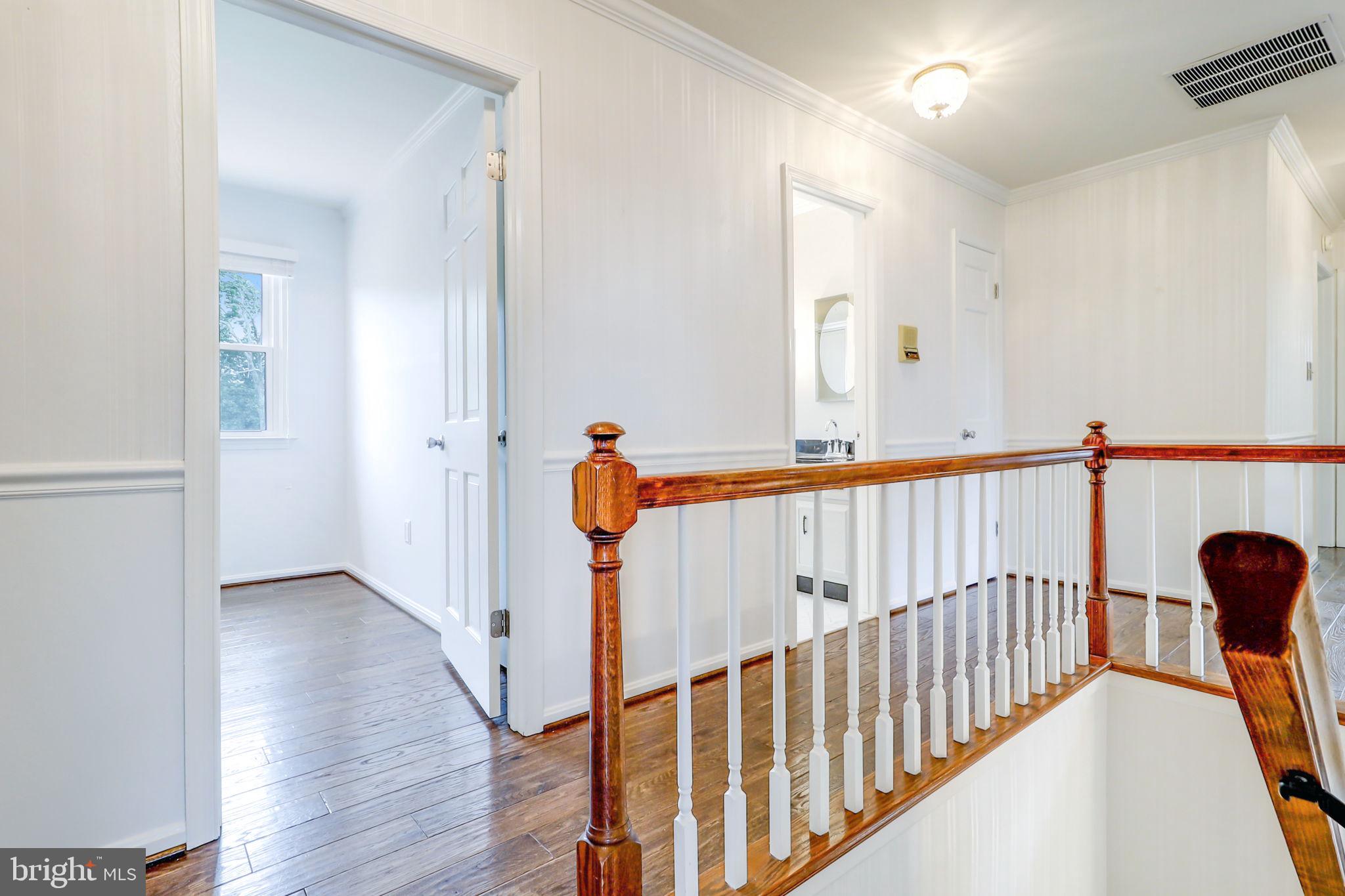 21960 Oatlands Road Aldie, VA 20105 - Photo 60 of 79 a view of a hallway with wooden floor and stairs
