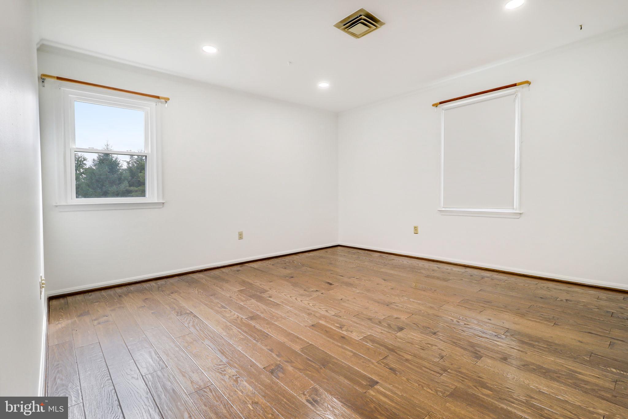 21960 Oatlands Road Aldie, VA 20105 - Photo 70 of 79 an empty room with wooden floor and windows
