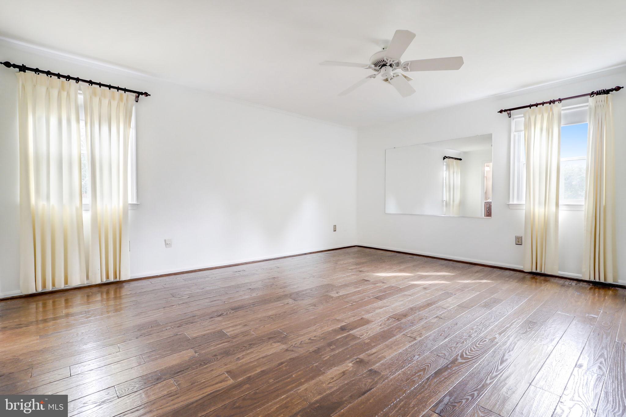 21960 Oatlands Road Aldie, VA 20105 - Photo 72 of 79 an empty room with wooden floor fan and windows