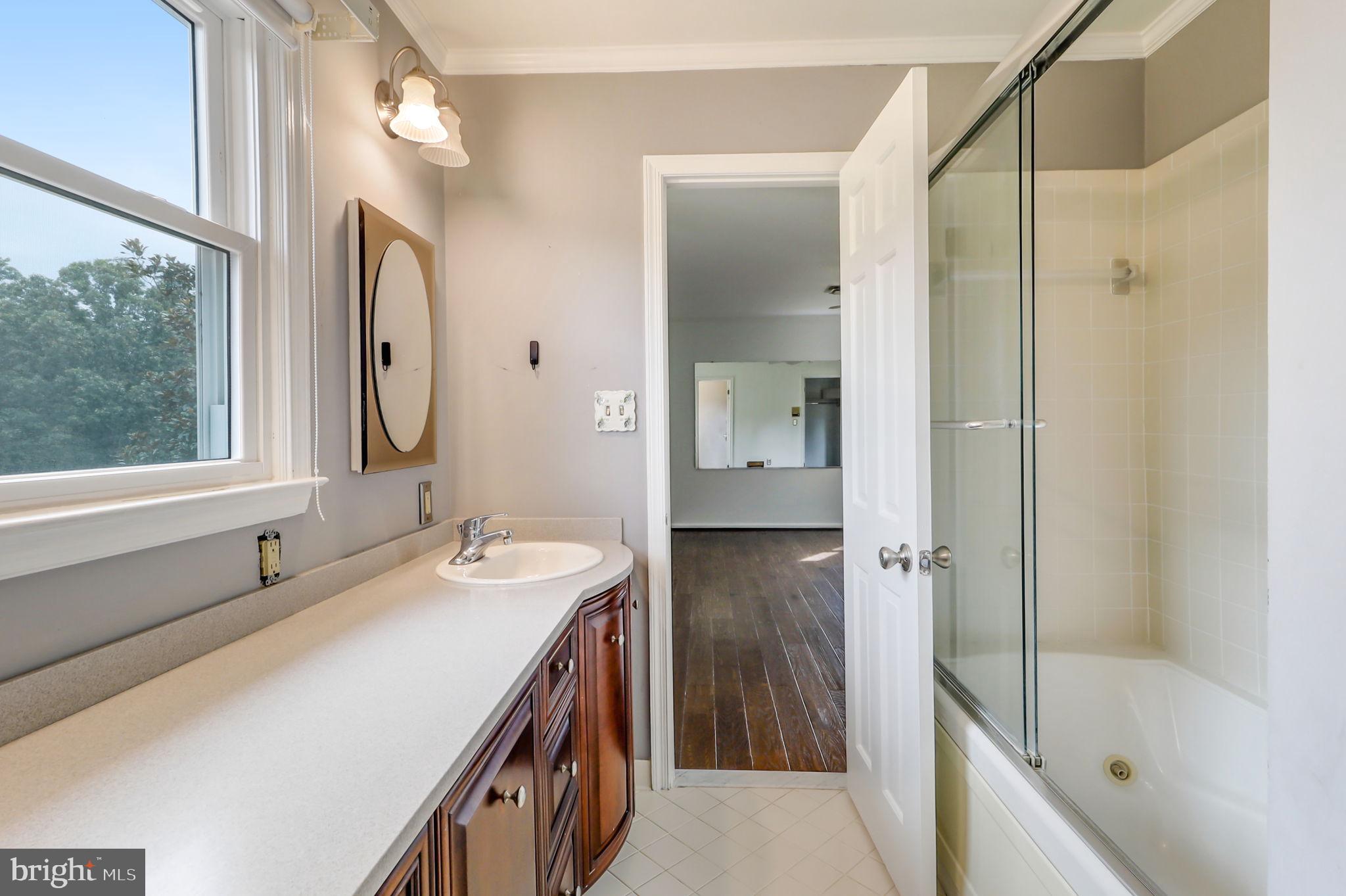 21960 Oatlands Road Aldie, VA 20105 - Photo 77 of 79 a bathroom with a tub sink and mirror