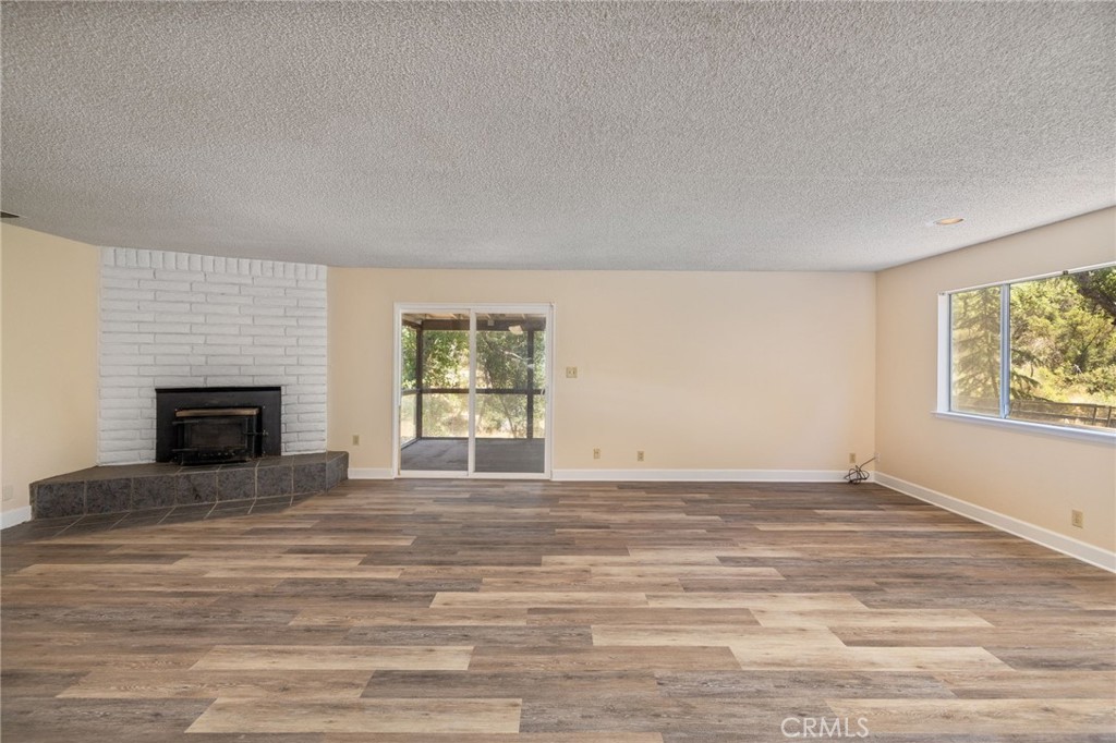 32413 Chickasaw Road Coarsegold, CA 93614 - Photo 18 of 66 a view of empty room with fireplace and window