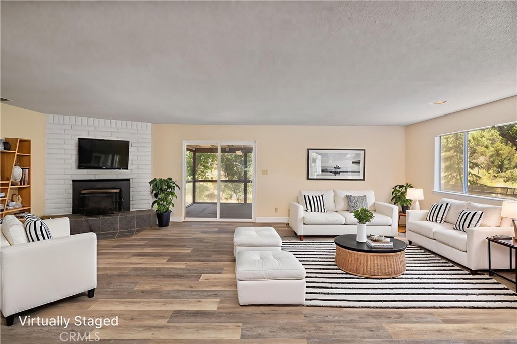 32413 Chickasaw Road Coarsegold, CA 93614 - Photo 2 of 66 a living room with furniture and a fireplace