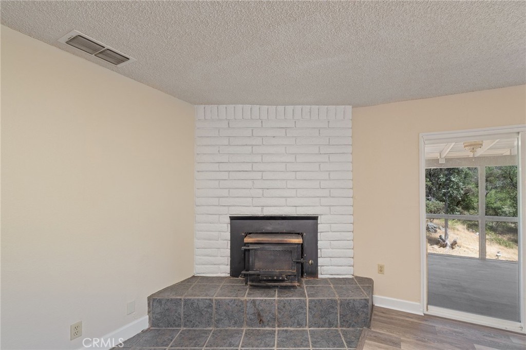 32413 Chickasaw Road Coarsegold, CA 93614 - Photo 21 of 66 a living room with furniture and a fireplace