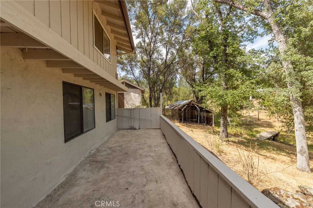 32413 Chickasaw Road Coarsegold, CA 93614 - Photo 59 of 66 a view of a balcony with wooden floor and fence