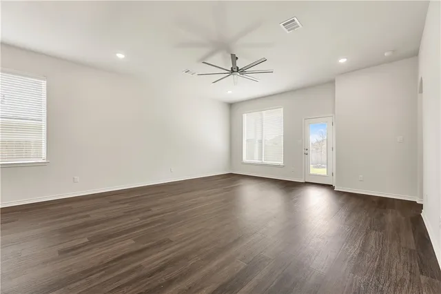 wooden floor in an empty room with a window