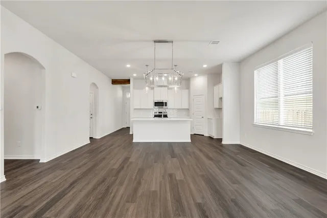 a view of an empty room and wooden floor