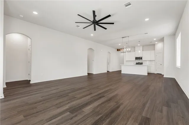 a view of a kitchen with a sink and wooden floor